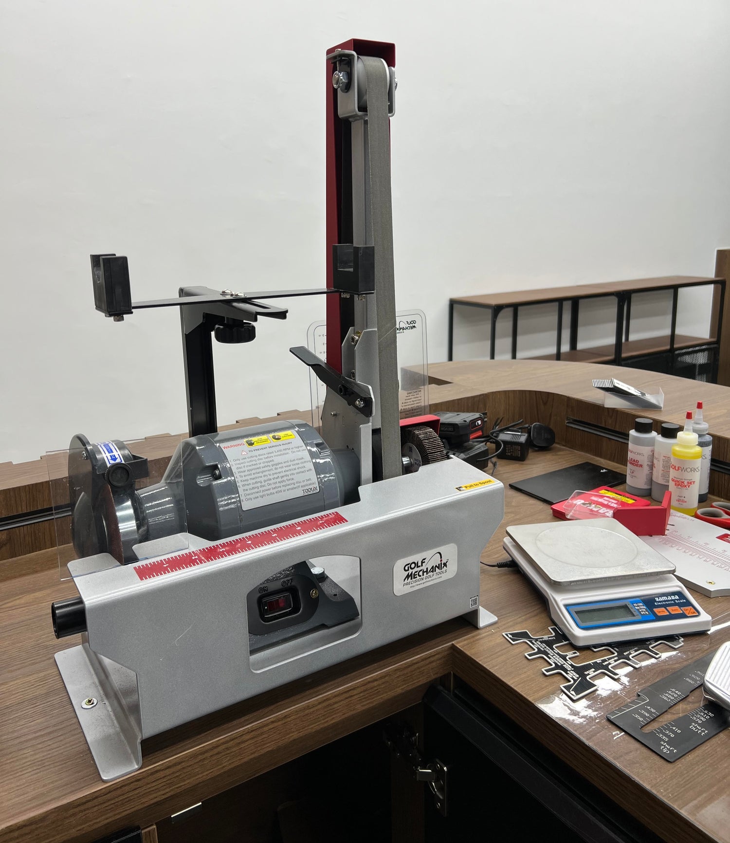 Shaft and Ferrule Prepping Machine with Flap Wheel in a Golf Workshop.